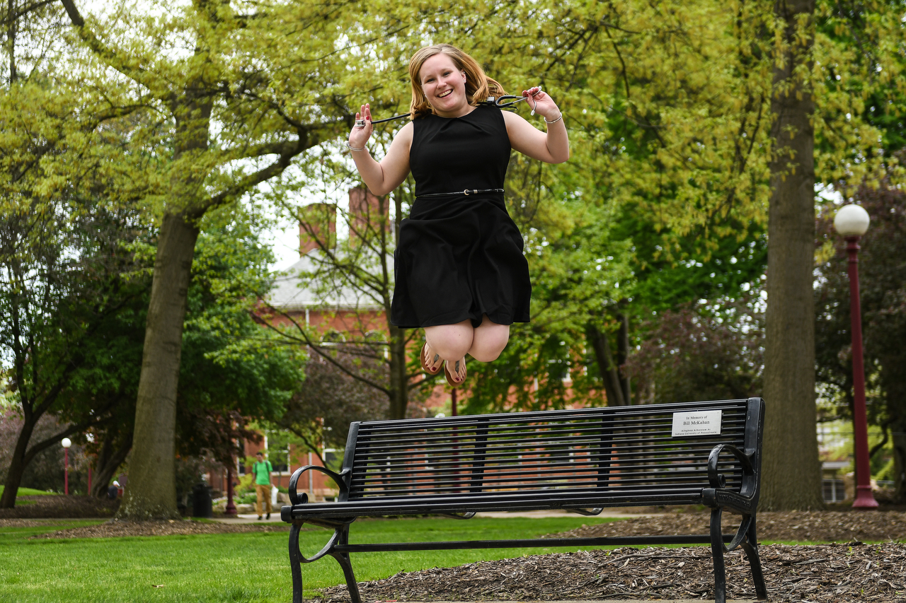 Nursing student jumping in the air